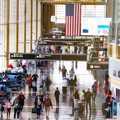 PHOTO: In this March 30, 2026, file photo, travelers walk on the main concourse of Terminal 2 at Ronald Reagan International Airport in Washington, D.C.