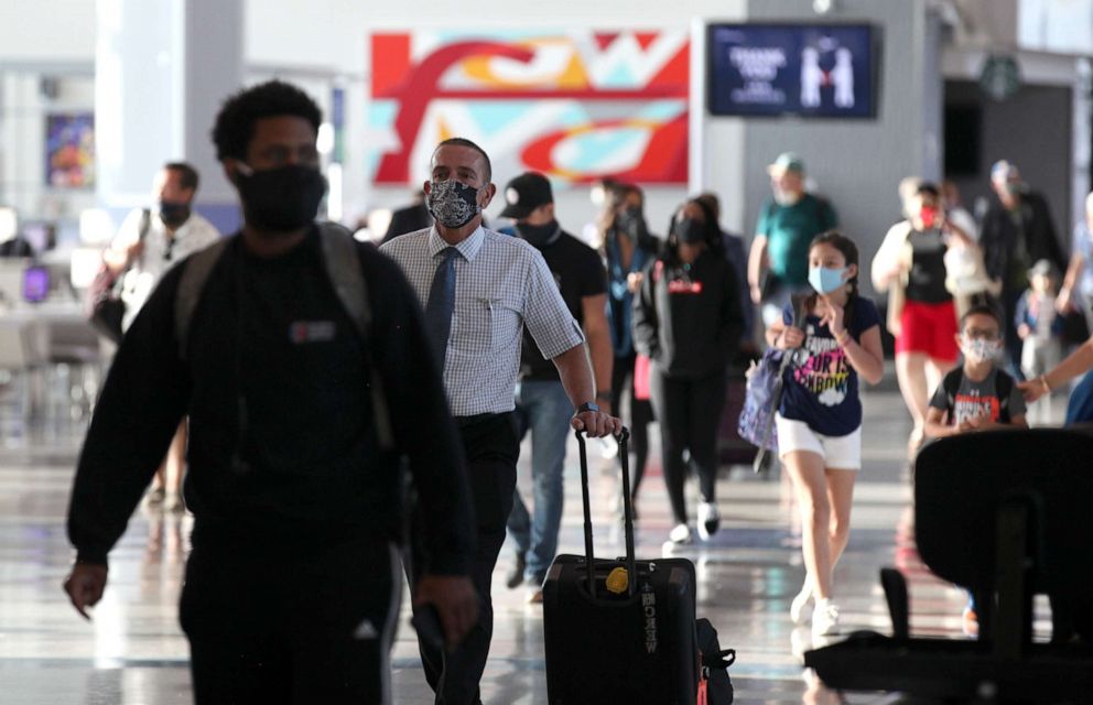 PHOTO: Passengers walk through the United Airlines terminal at George Bush Intercontinental Airport on May 11, 2020 in Houston.