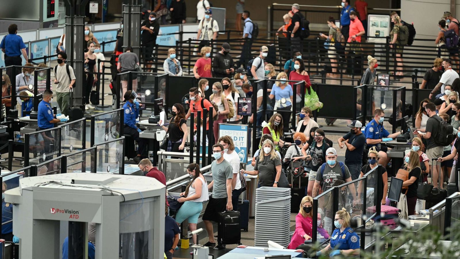 PHOTO: Travelers are in the line at the security check point of Denver International Airport in Denver, July 7, 2021.