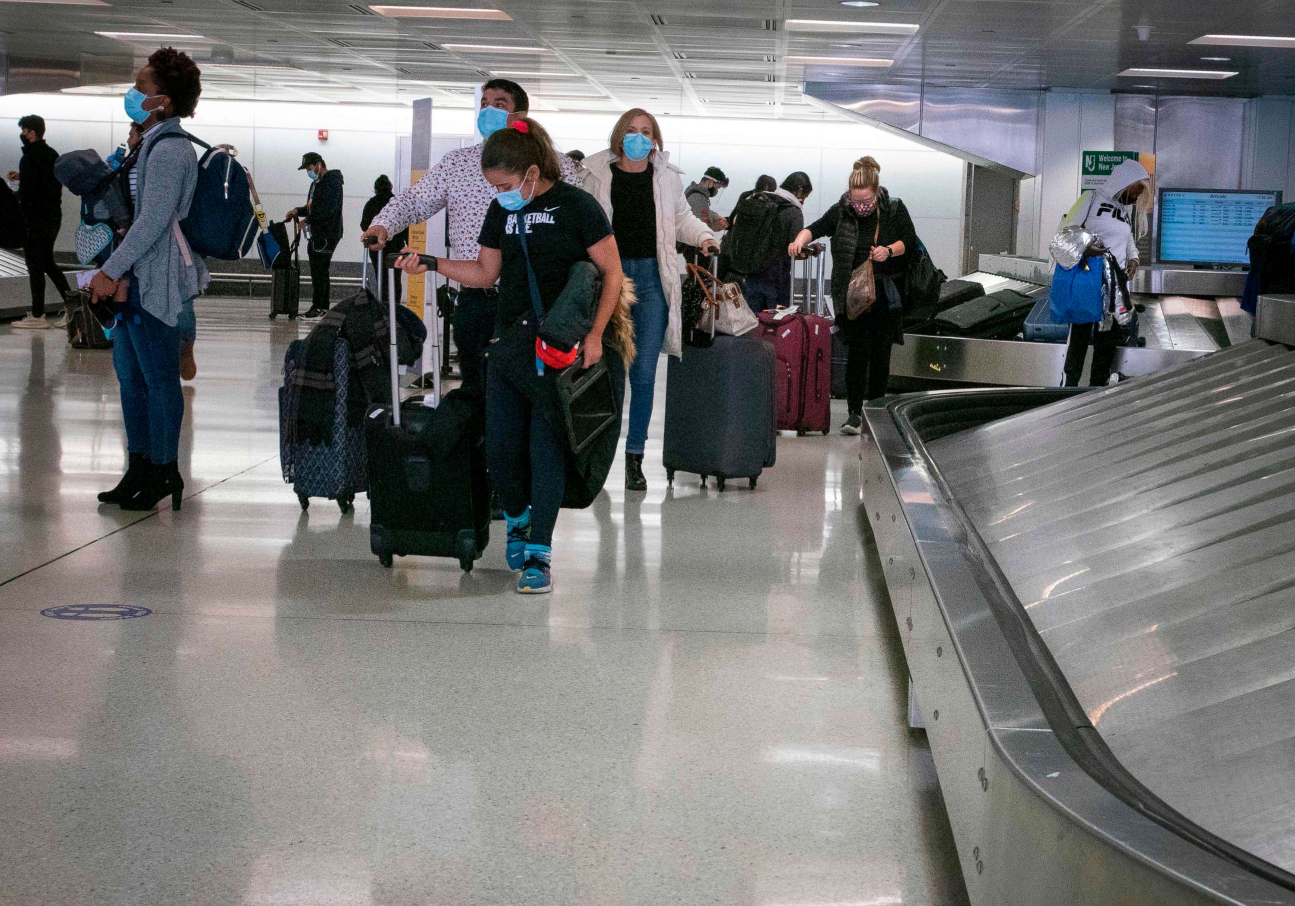 PHOTO: Travelers retrieve their luggage at Newark International Airport on Nov. 21, 2020, in Newark, NJ.