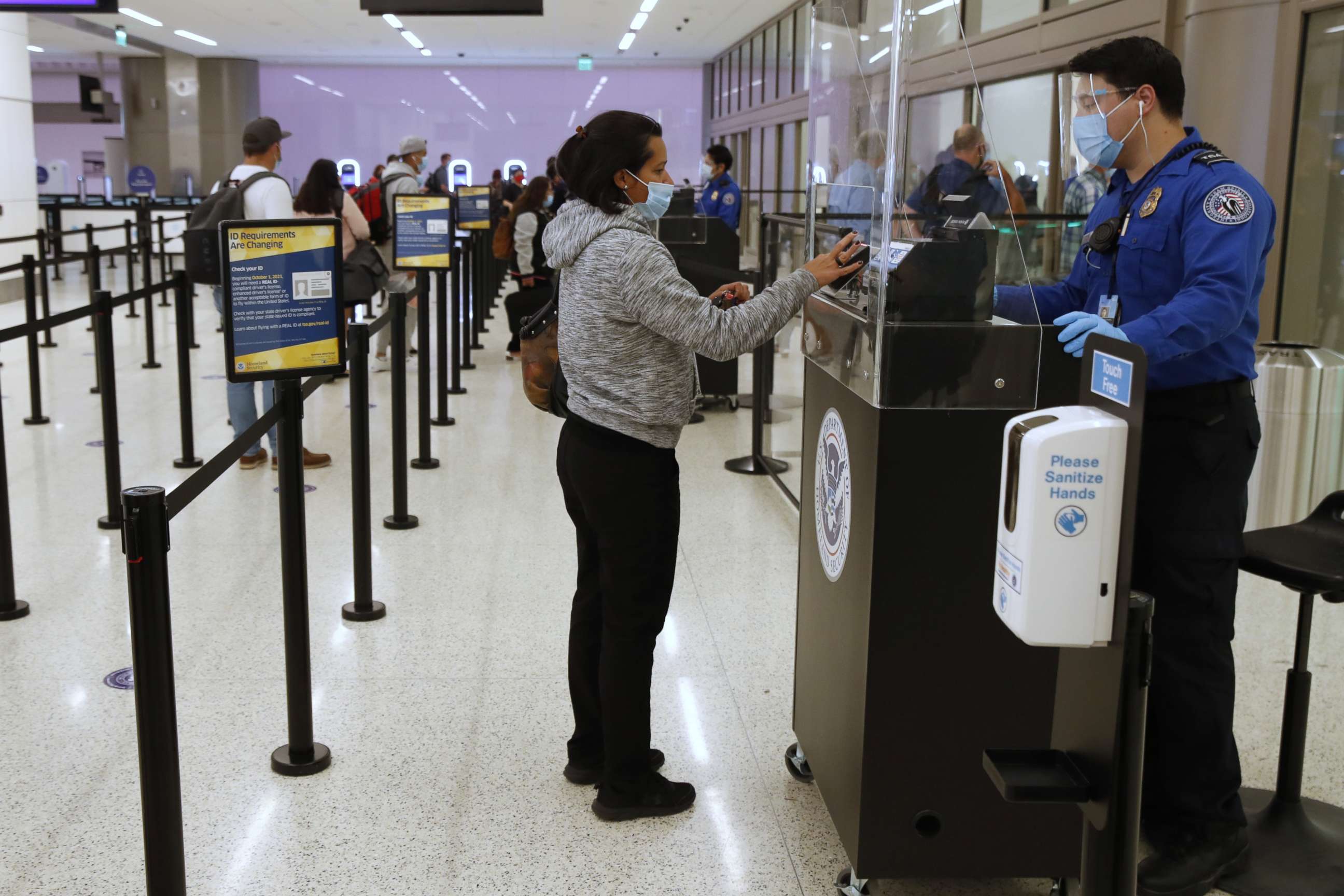 PHOTO: A TSA agent checks the identification of a travelers at the security screening center at Salt Lake City International Airport in Salt Lake City, Sept. 15, 2020.