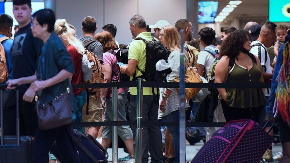 PHOTO: Travelers make their way through a TSA screening line at Orlando International Airport, July 1, 2022. 