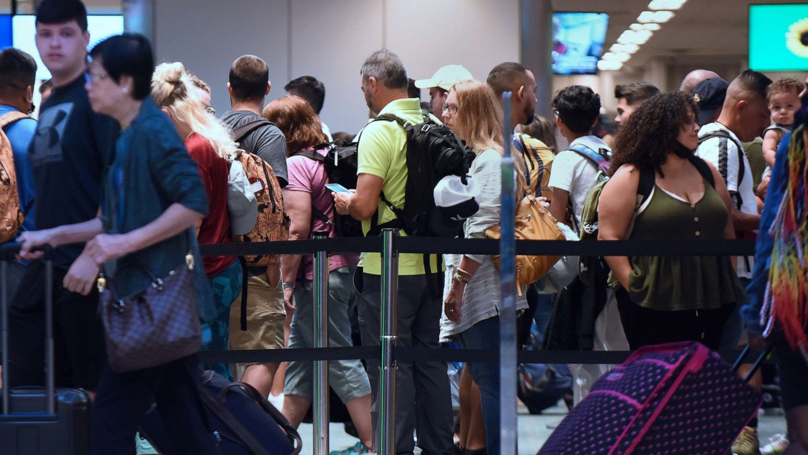 PHOTO: Travelers make their way through a TSA screening line at Orlando International Airport, July 1, 2022.