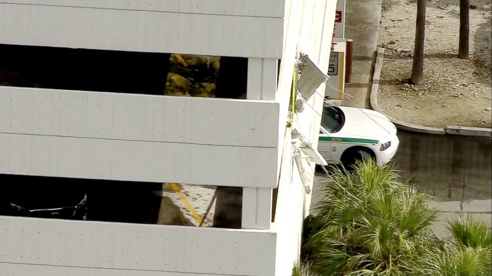 PHOTO: A worker at Miami International Airport suffered minor injuries after his van plunged off the fourth floor of an airport parking lot, crashing into the roadway below.