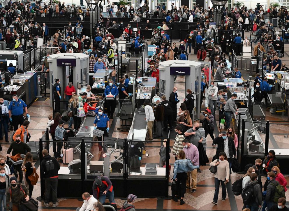 PHOTO: Travelers make their way through TSA security at Denver International Airport the day before Thanksgiving on Nov. 24, 2021, in Denver.