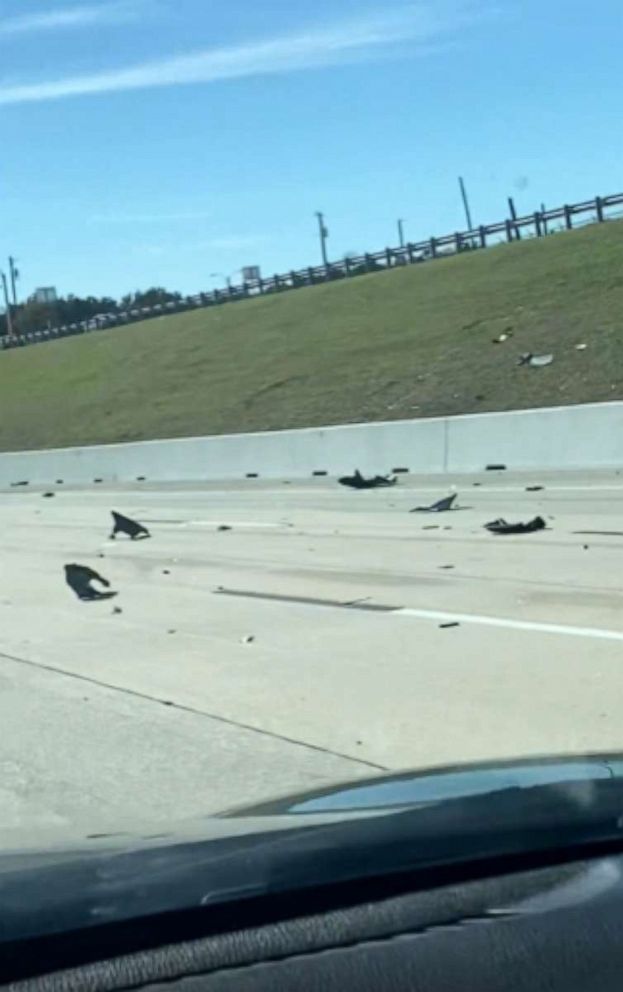 PHOTO: In this screen grab from a video, debris is shown on a highway after a crash at a World War II airshow at Dallas Executive Airport, Nov. 12, 2022.