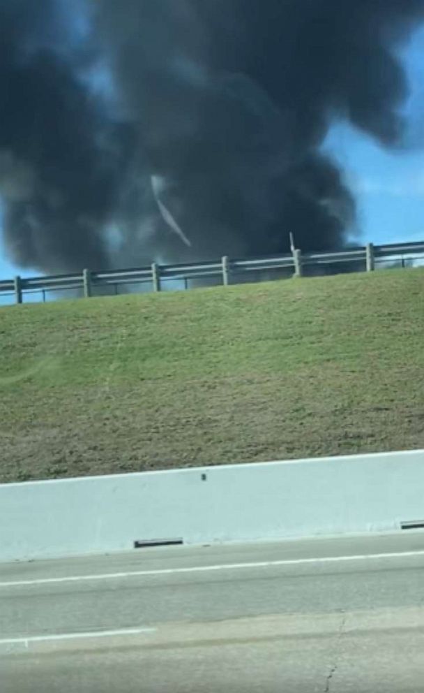 Photo: In this screengrab video, smoke rises after a crash at a World War II air show at Dallas Executive Airport, Nov. 12, 2022.
