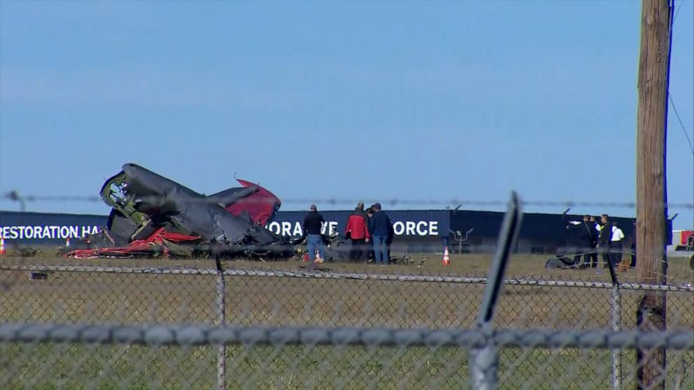 PHOTO: In this screen grab from a video, people are shown at the scene of a crash at a World War II airshow at Dallas Executive Airport, Nov. 12, 2022.