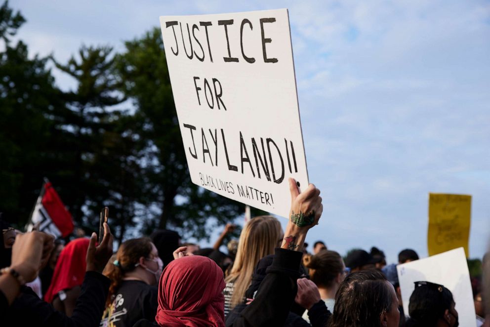 PHOTO: A demonstrator holds a sign during a vigil in honor of Jayland Walker on July 8, 2022 in Akron, Ohio.