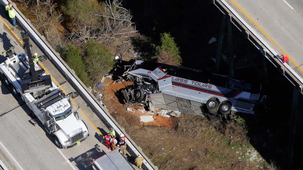Rescue crews work at the scene of a deadly charter bus crash, March 13, 2018, in Loxley, Ala. The bus carrying Texas high school band members home plunged into a ravine before dawn Tuesday. 