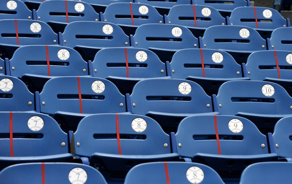 PHOTO: Red tape blocks off some seats but not others in an attempt to promote social distancing before two large high school graduation ceremonies at Hoover Metropolitan Stadium in Hoover, Ala., Tuesday, May 19, 2020.