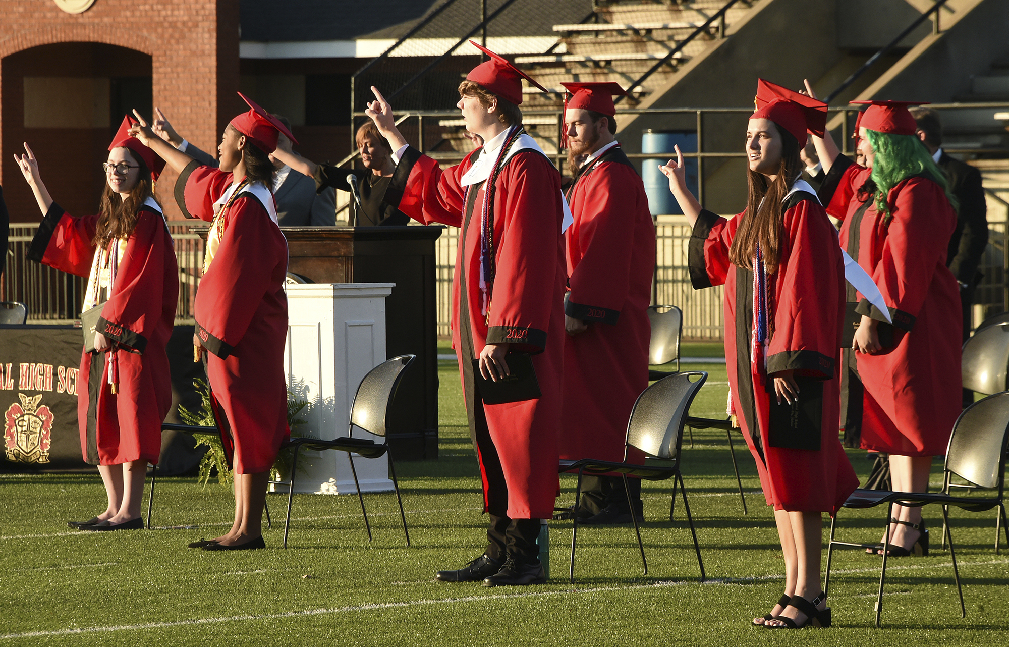 PHOTO: Central High School graduates gesture during the  first of five graduation ceremonies at Garrett-Harrison Stadium in in Phenix City, Ala., May 12, 2020.