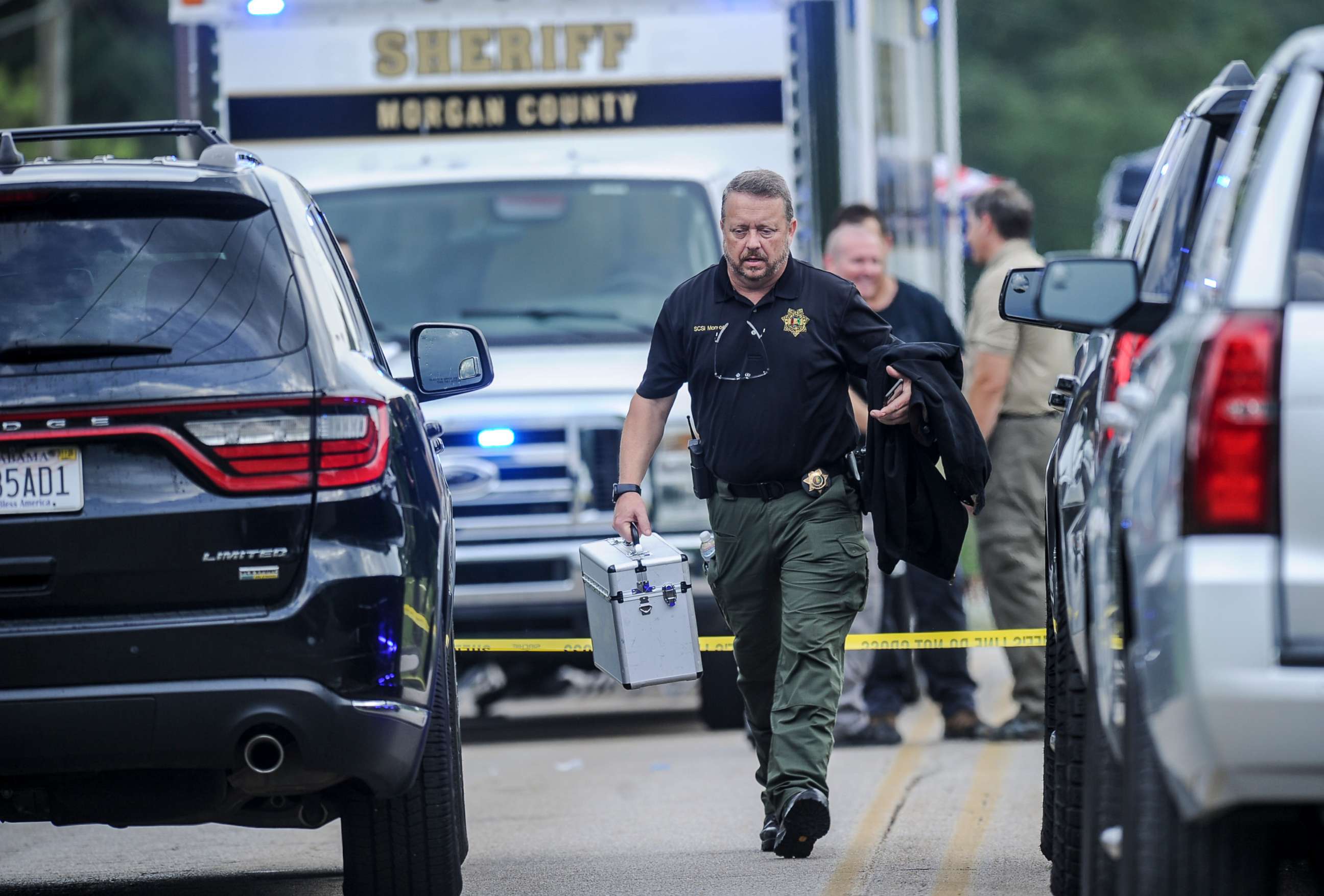 PHOTO: A Morgan County, Ala. investigator works at the scene, Friday, June 5, 2020, in Valhermoso Springs, Ala., where numerous people were found fatally shot. 