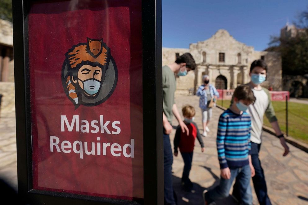 PHOTO: Visitors wearing face masks leave the Alamo, March 3, 2021, in San Antonio. Gov. Greg Abbott is lifting a mask mandate and business capacity.