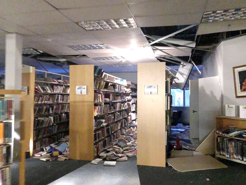 PHOTO: In this courtesy image books and ceiling tiles litter the floor at the The Mat-Su College library in Anchorage, Ala., Nov. 30, 2018.