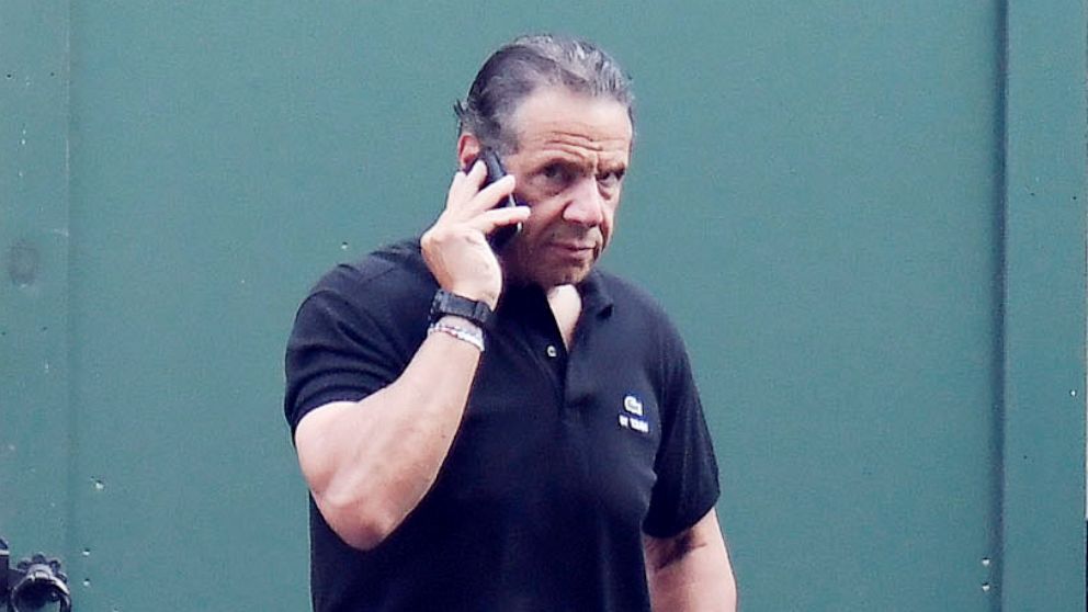 PHOTO: Gov. Andrew Cuomo talks on the phone while walking at the New York state Executive Mansion in Albany N.Y., Aug. 7, 2021.