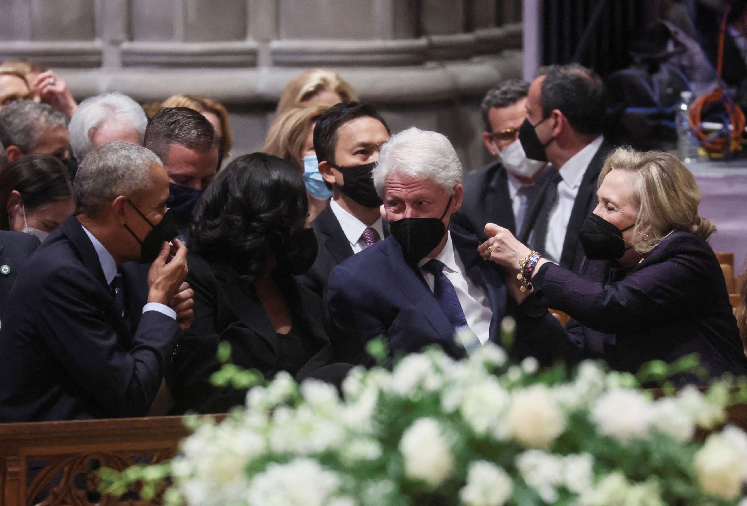 PHOTO:Former President Obama and Michelle Obama watch as Hillary Clinton pins a Ukrainian flag pin on the jacket of former President Bill Clinton as they gather for the funeral of former Secretary of State Madeleine Albright in Washington, April 27, 2022.