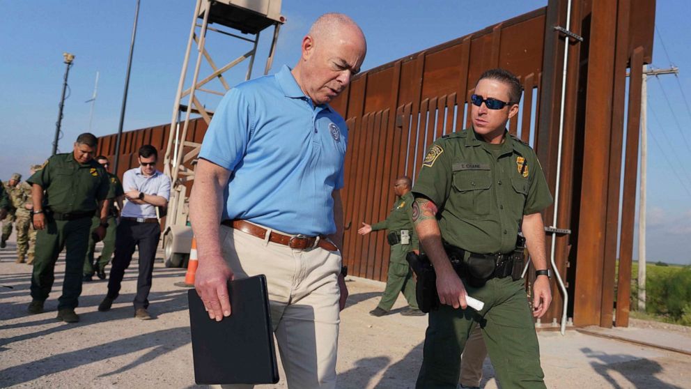PHOTO: In this May 17, 2022, file photo, Homeland Security Secretary Alejandro Mayorkas listens to Deputy patrol agent in charge of the US Border Patrol Anthony Crane as he tours the section of the border wall, in Hidalgo, Texas.