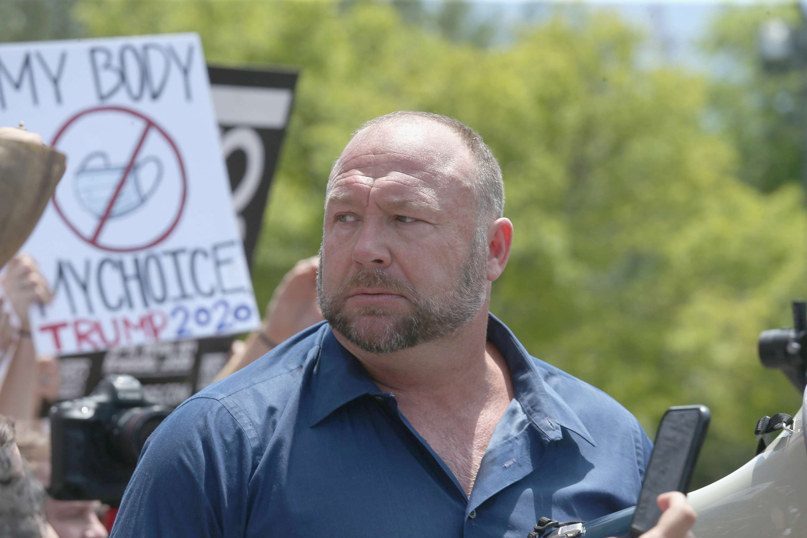 PHOTO: Alex Jones speaks to protestors gathered outside the Texas State Capitol in Austin, Texas, April 25, 2020.