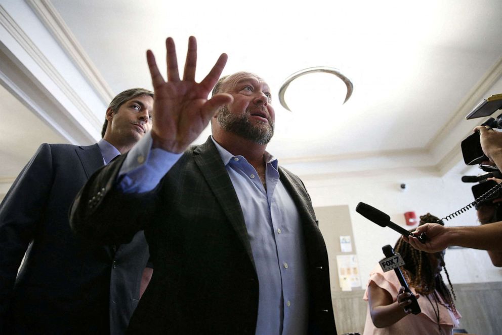 PHOTO: Alex Jones talks to media during a midday break at the Travis County...