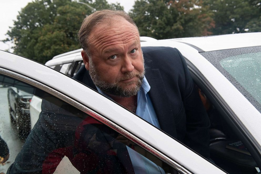 PHOTO: Conspiracy theorist Alex Jones enters a private car after talking to the media outside State of Connecticut Superior Court during the Sandy Hook hoax defamation trialin Waterbury Conn., Oct. 4, 2022 . 