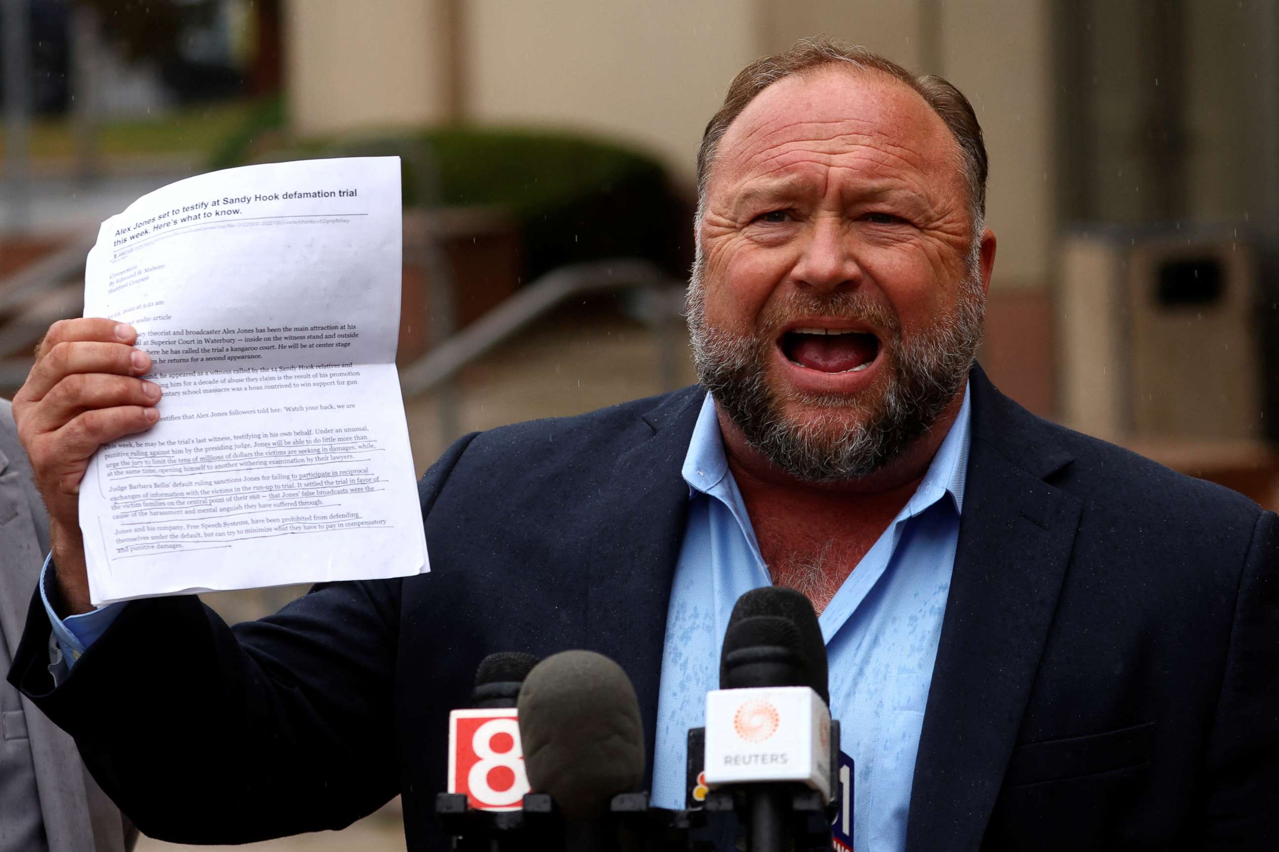 PHOTO: Infowars founder Alex Jones speaks to the media after appearing at his Sandy Hook defamation trial at Connecticut Superior Court in Waterbury, Conn., Oct. 4, 2022.