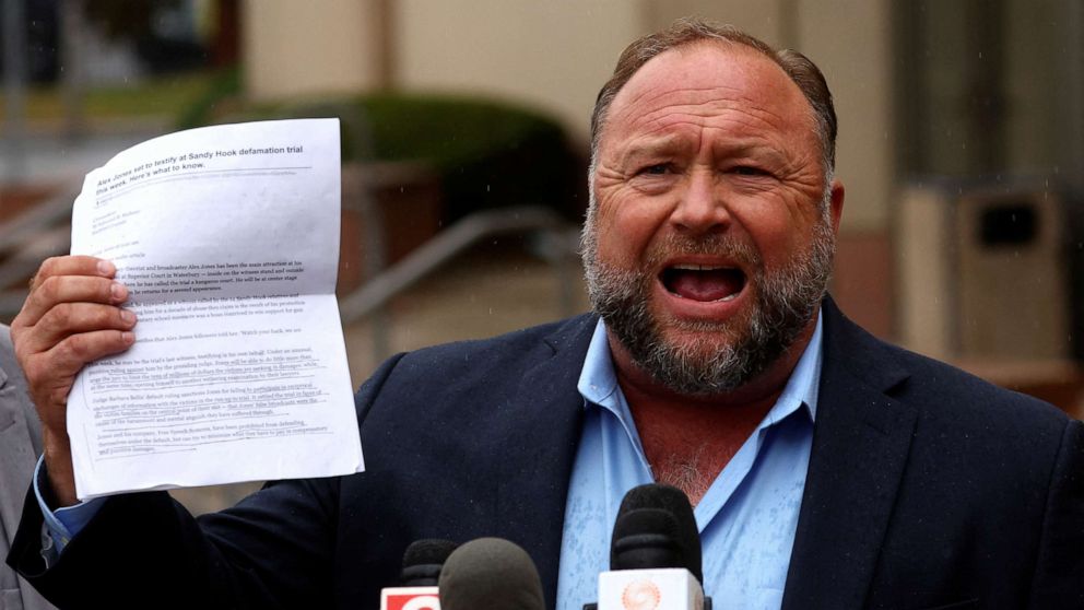 PHOTO: Infowars founder Alex Jones speaks to the media after appearing at his Sandy Hook defamation trial at Connecticut Superior Court in Waterbury, Conn., Oct. 4, 2022.
