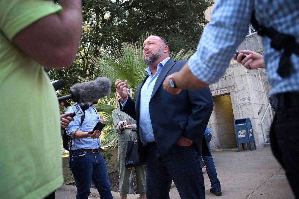 PHOTO: Alex Jones steps outside of the Travis County Courthouse, to do interviews with media after he was questioned under oath about text messages and emails by lawyer Mark Bankston, in Austin, Texas, Aug. 3, 2022.
