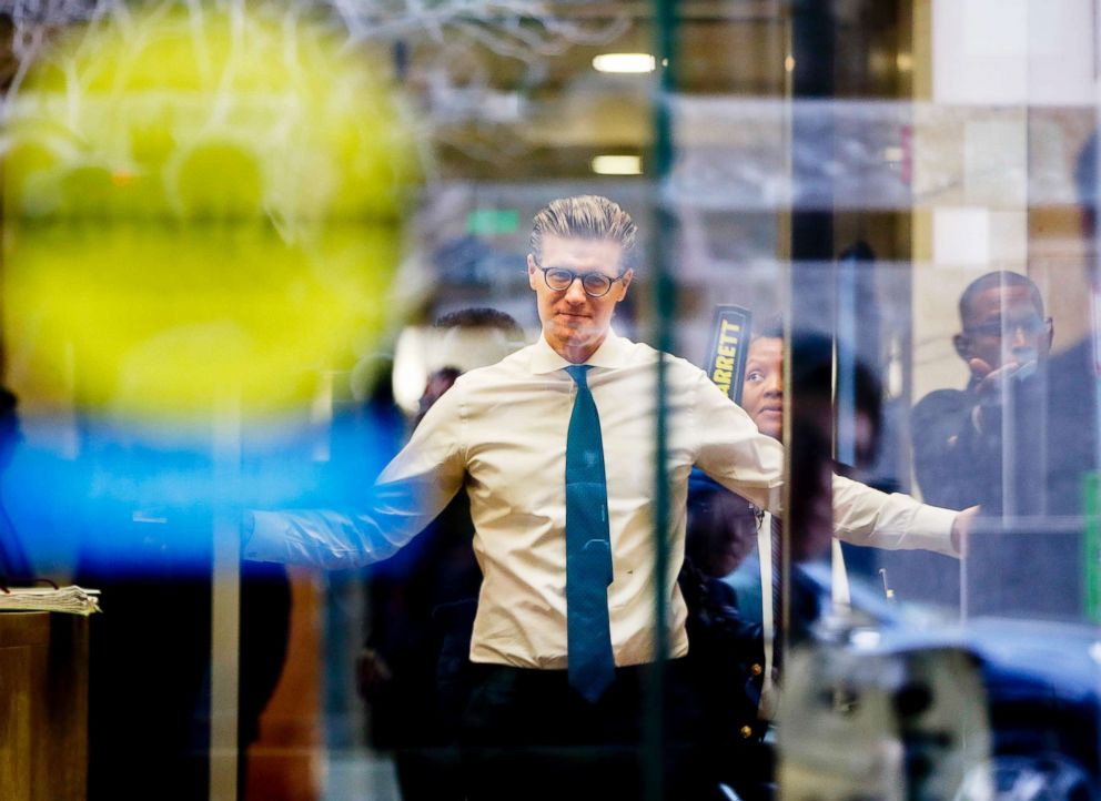 PHOTO: Alex van der Zwaan raises his arms as he goes through a security checkpoint on April 3, 2018, during his arrival Federal District Court in Washington, D.C.