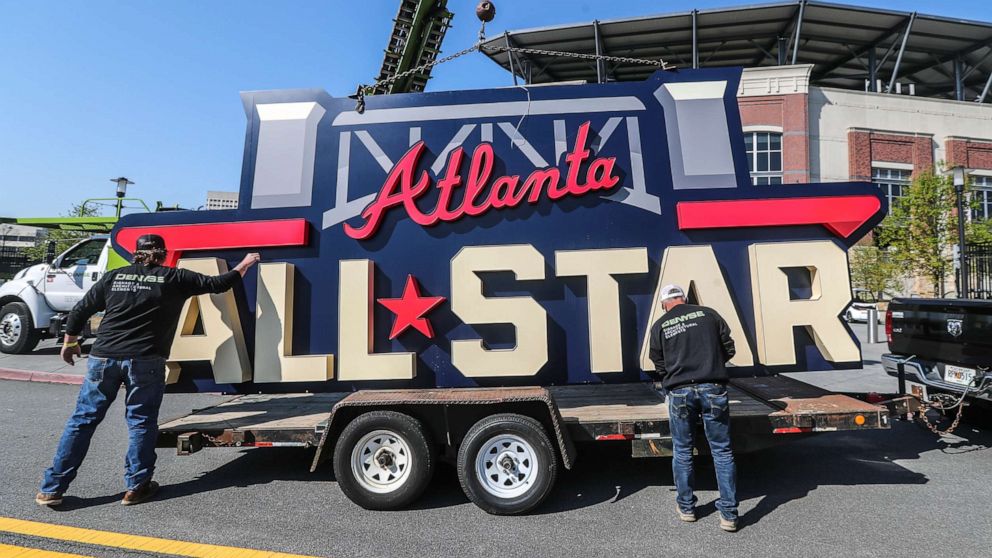 PHOTO: Workers load an All-Star sign onto a trailer after it was removed from Truist Park in Atlanta, April 6, 2021, after Major League Baseball pulled the game from Atlanta over objections to sweeping changes to Georgia's voting laws.