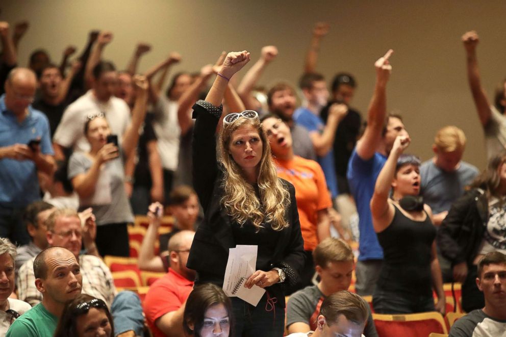 PHOTO: People react as white nationalist Richard Spencer, who popularized the term "alt-right" speaks at the Curtis M. Phillips Center for the Performing Arts on Oct. 19, 2017 in Gainesville, Fla.