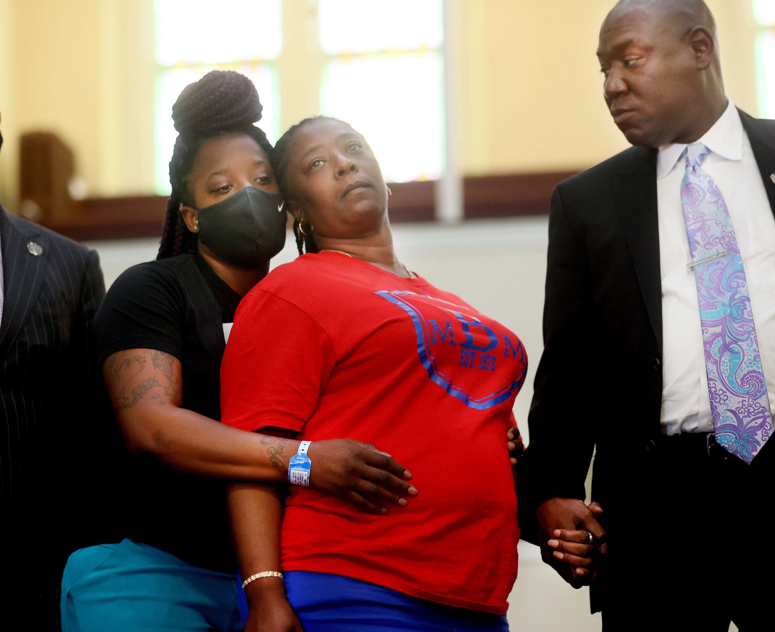 PHOTO: Tasheta Motley is held by her daughter Tammy Sykes and holds hands with civil rights attorney Benjamin Crump before a press conference, Aug. 10, 2021, at Mt. Olive CME Church about the shooting death of her brother, Alvin Motley, in Memphis, Tenn.