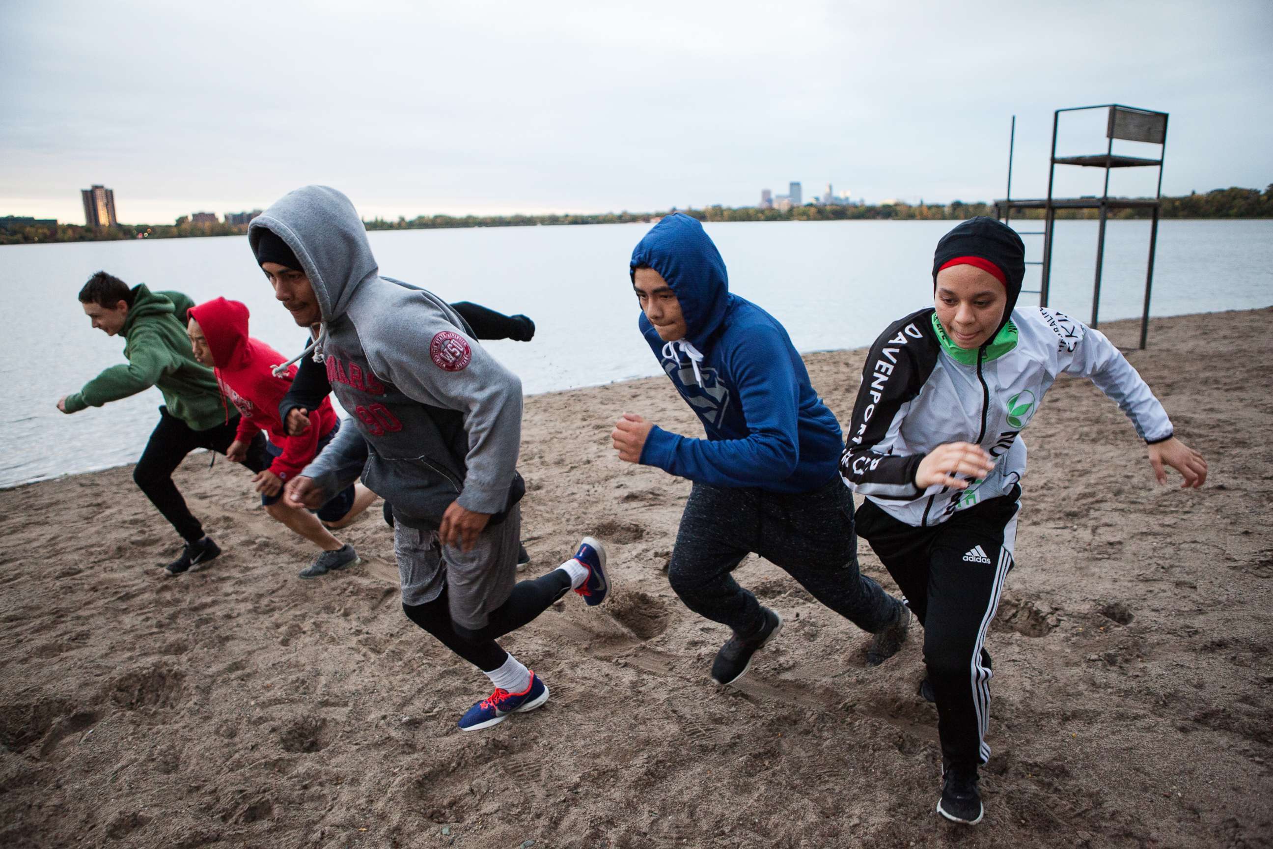 PHOTO: Amaiya Zafar sprints with fellow Circle of Discipline boxers by Lake Calhoun in Minneapolis before heading to the gym.