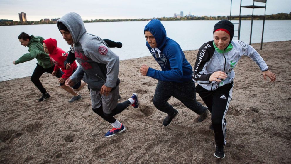 PHOTO: Amaiya Zafar sprints with fellow Circle of Discipline boxers by Lake Calhoun in Minneapolis before heading to the gym.