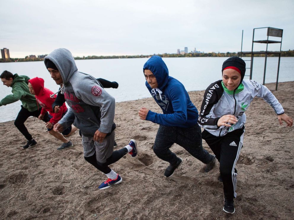 PHOTO: Amaiya Zafar sprints with fellow Circle of Discipline boxers by Lake Calhoun in Minneapolis before heading to the gym.