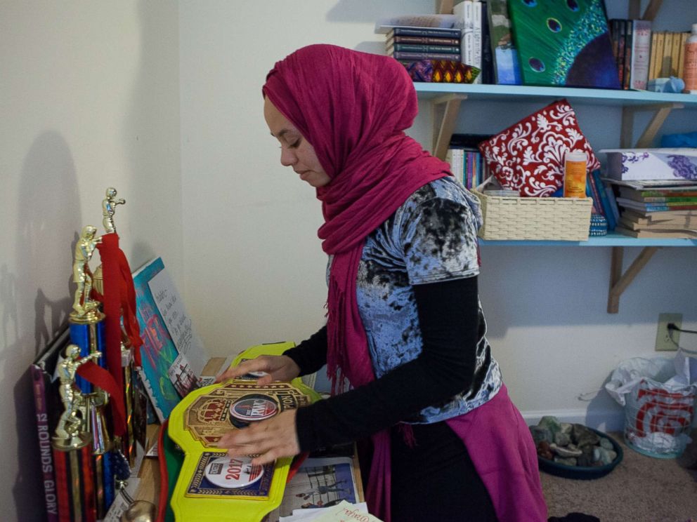 PHOTO: Amaiya Zafar looks at the belt that her opponent, Aliyah Charbonier, handed her after she was disqualified for not removing her hijab.