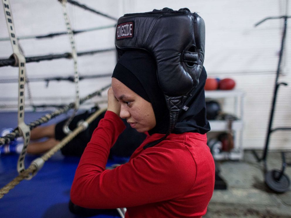 PHOTO: Amaiya wears her hijab under her helmet as she prepares to spar at Circile of Discipline gym.