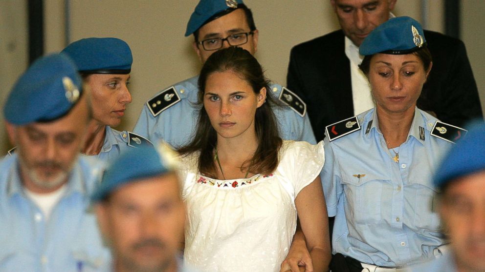 PHOTO: Amanda Knox, center, is escorted by Italian penitentiary police officers from Perugia's court after a hearing in central Italy in this Sept. 16, 2008 file photo.