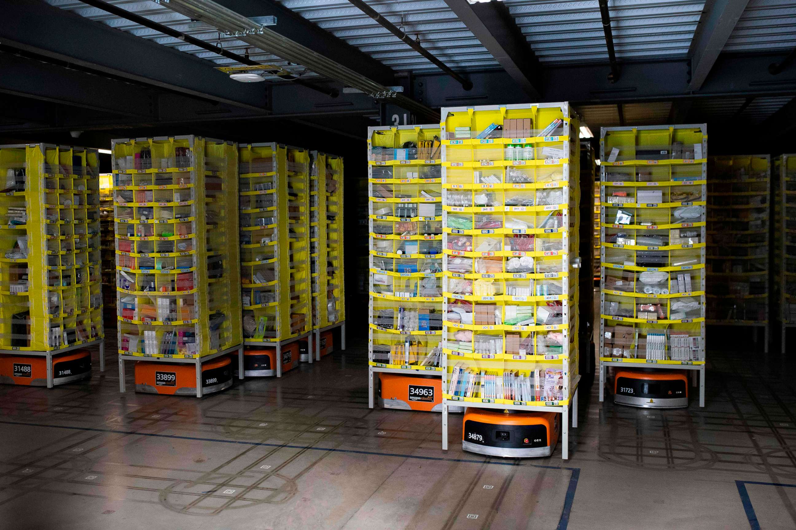 PHOTO: Hundreds of lawnmower-sized robots that move around shelving units in a closed field are seen during a tour of Amazon's Fulfillment Center, Sept. 21, 2018, in Kent, Wash.