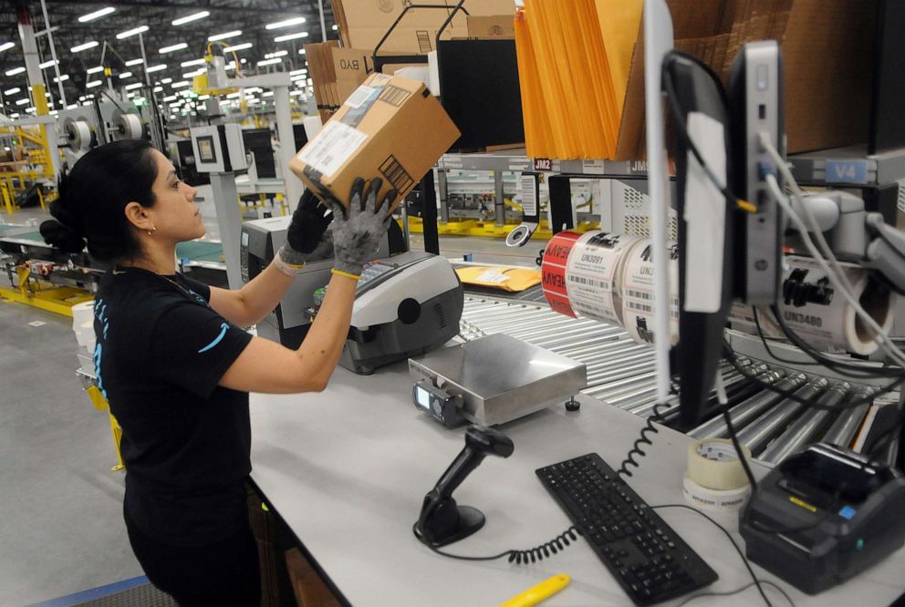 PHOTO: An Amazon associate processes a package for delivery at the newest Amazon Robotics fulfillment center during its first public tour, April 12, 2019, in Orlando, Florida.