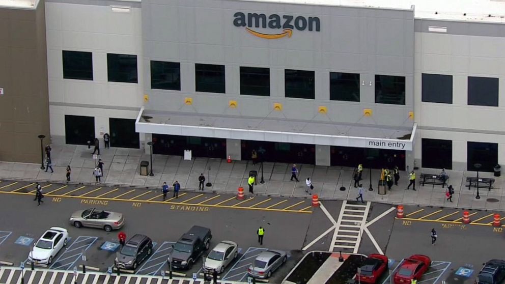 PHOTO: People walk out of the Amazon fulfillment center in Staten Island, New York, March 30, 2020.