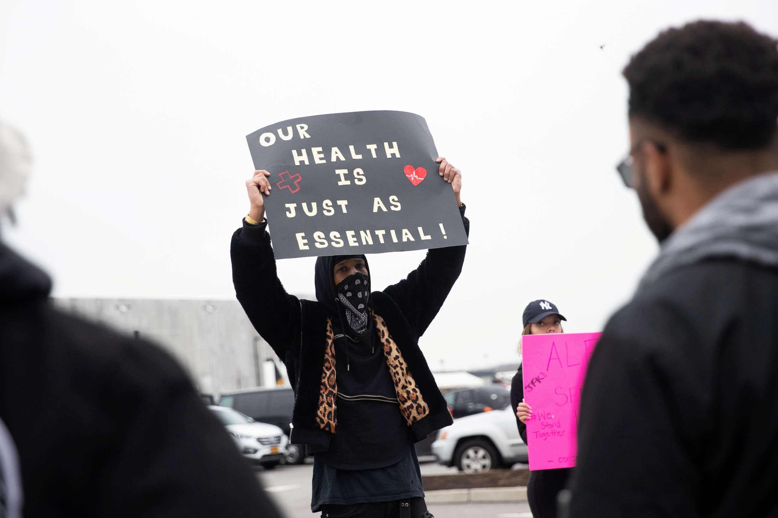 PHOTO: Christian Smalls holds a sign at an Amazon distribution center during the outbreak of the coronavirus disease, in the Staten Island borough of New York, March 30, 2020.