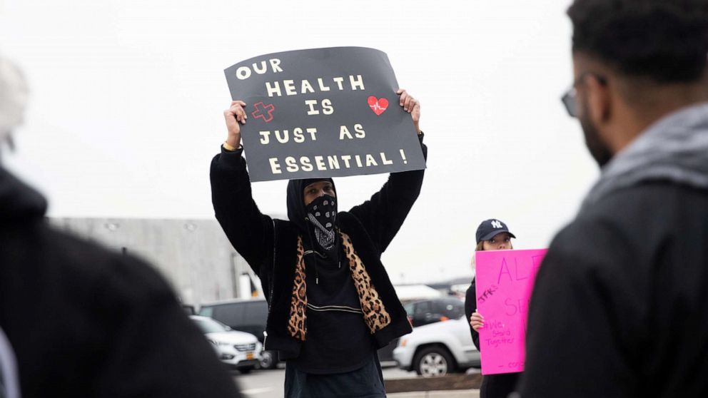PHOTO: Christian Smalls holds a sign at an Amazon distribution center during the outbreak of the coronavirus disease, in the Staten Island borough of New York, March 30, 2020.
