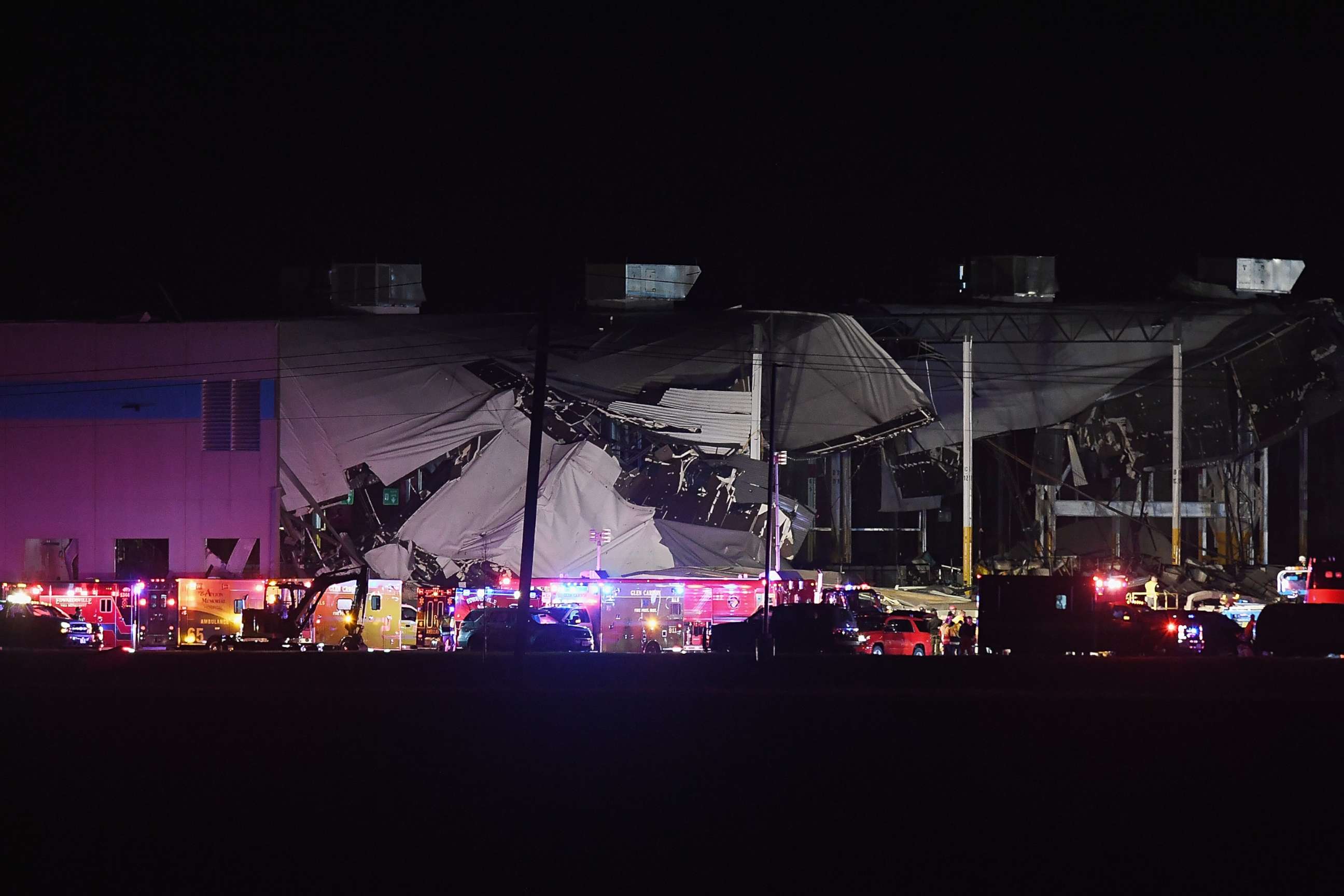 PHOTO: First responders surround a damaged Amazon Distribution Center on Dec. 10, 2021, in Edwardsville, Ill. According to reports, the Distribution Center was struck by a tornado Friday night.