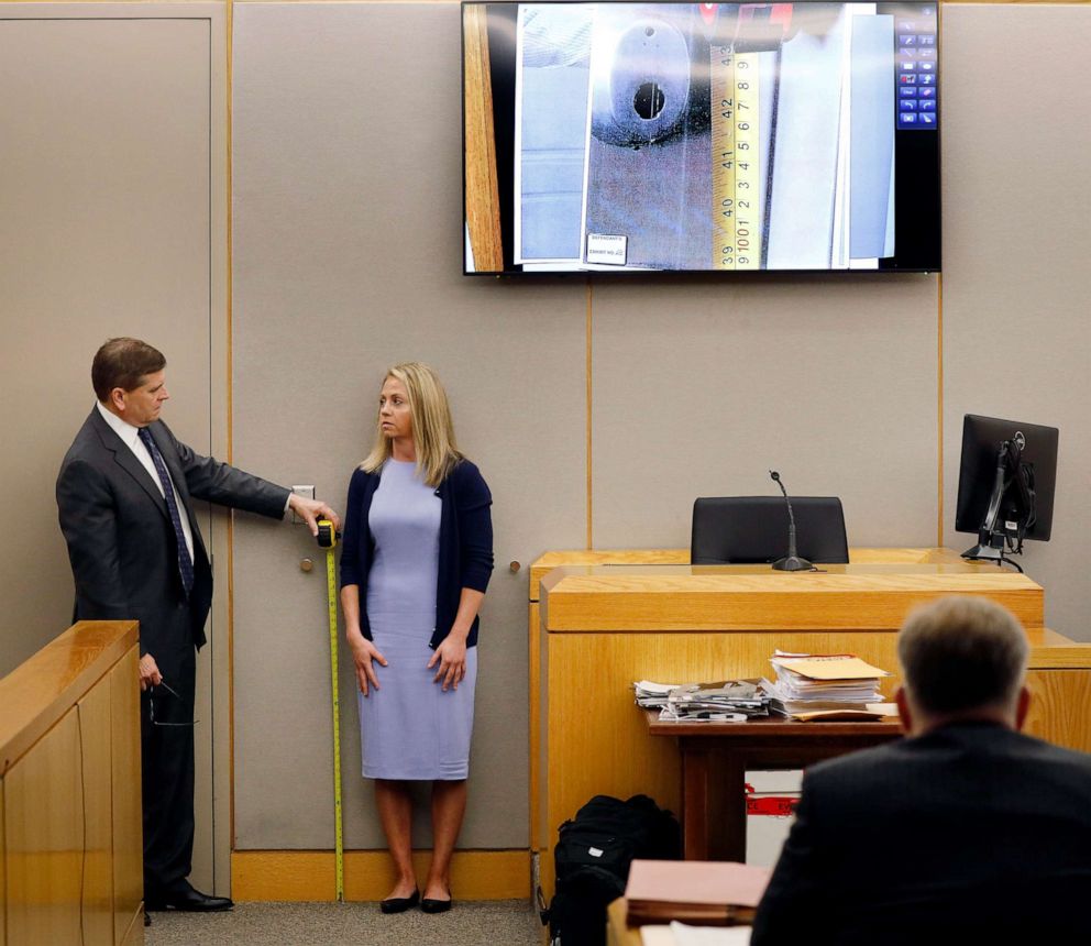 PHOTO: Defense attorney Toby Shook measures the height of a keyhole as fired Dallas police officer Amber Guyger stand against the courtroom wall as she testifies in her murder trial, Sept. 27, 2019, in Dallas.
