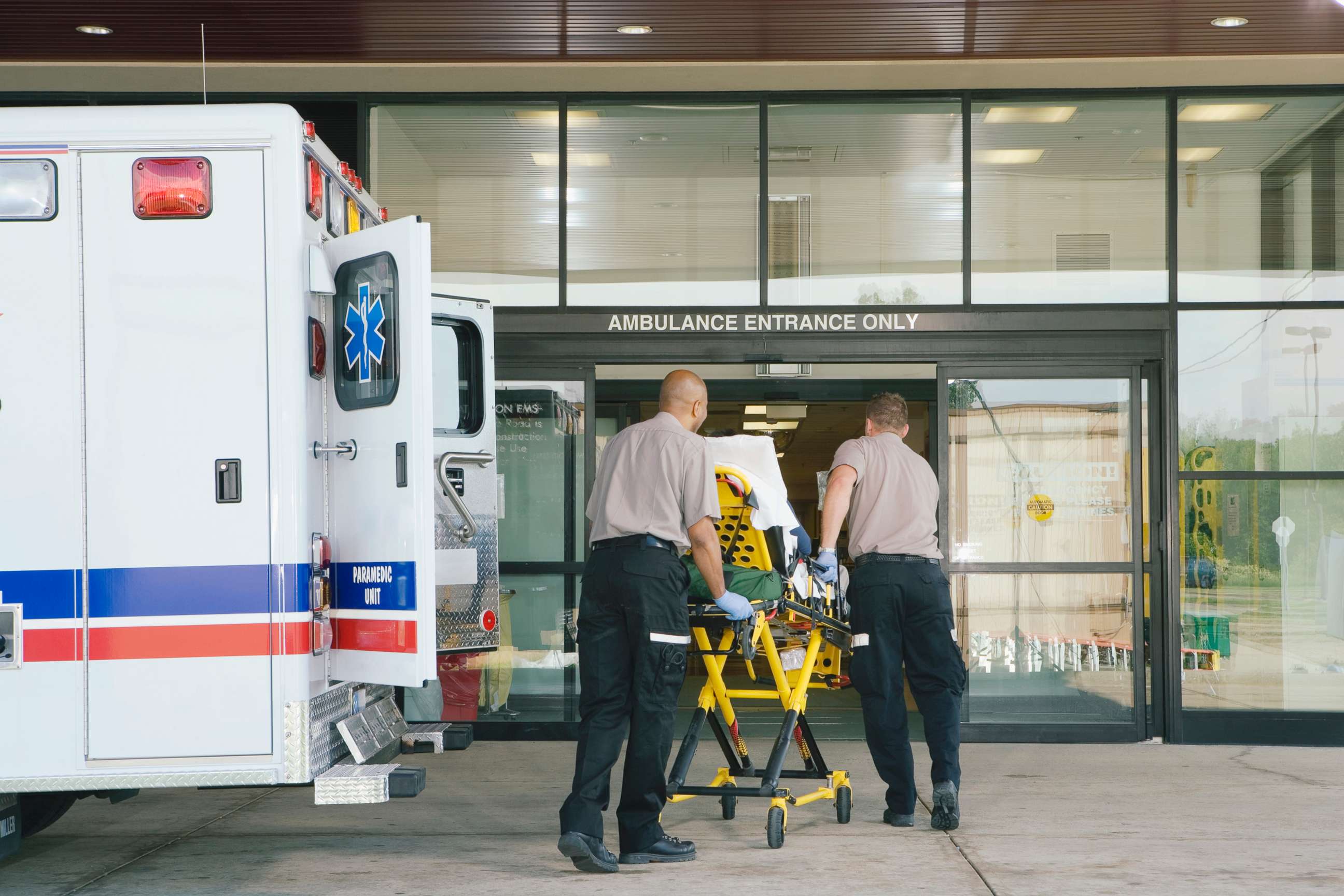 PHOTO: Paramedics take a patient on stretcher from the ambulance to the hospital.