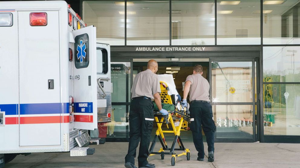 PHOTO: Paramedics take a patient on stretcher from the ambulance to the hospital.