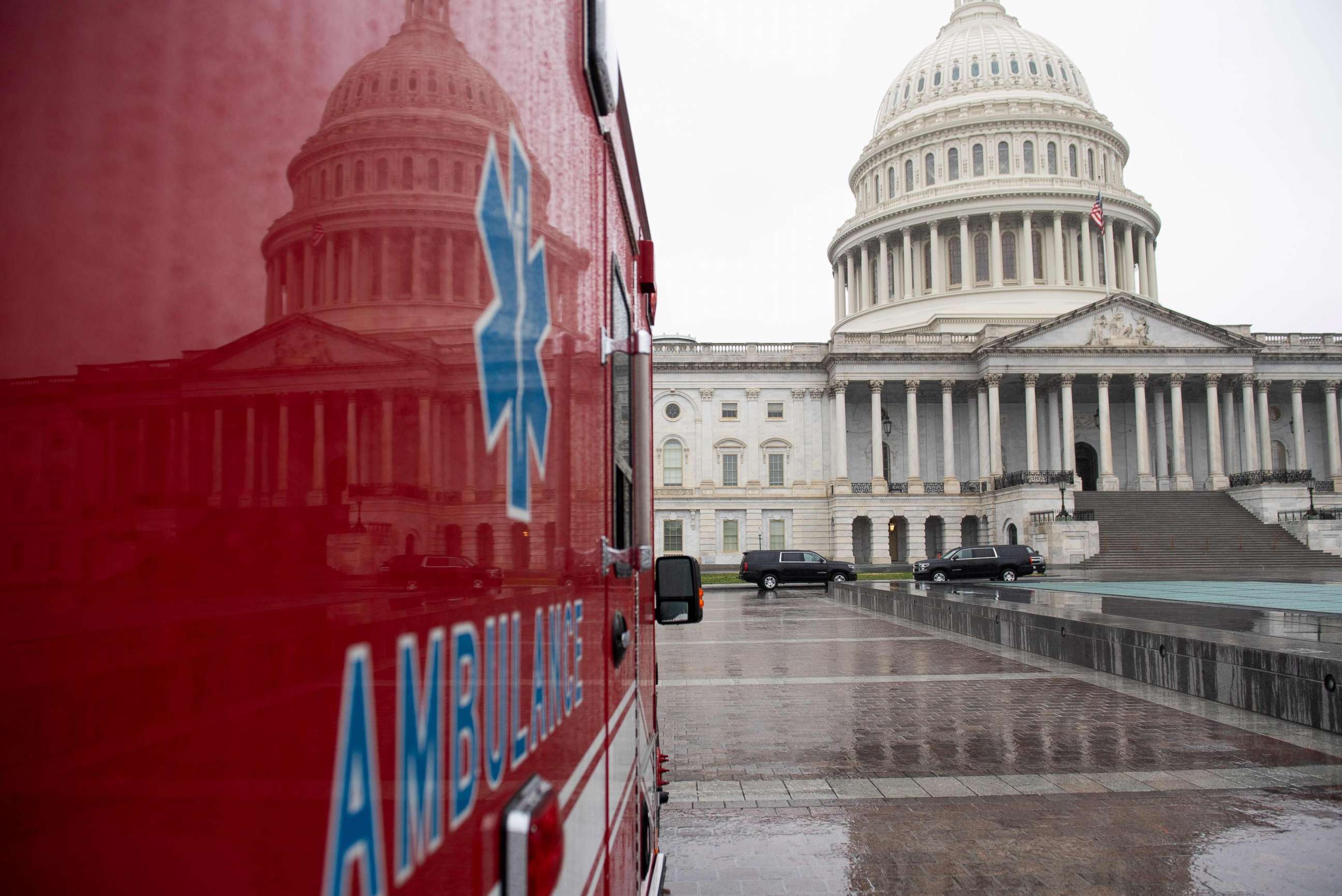 PHOTO: An ambulance sits outside the U.S. Capitol in Washington, D.C., on March 23, 2020, as the Senate continues negotiations on an economic relief package in response to the coronavirus pandemic.