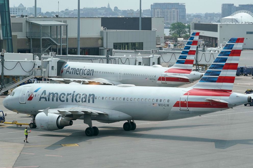 PHOTO: In this July 21, 2021, file photo, American Airlines passenger jets prepare for departure near a terminal at Boston Logan International Airport in Boston.