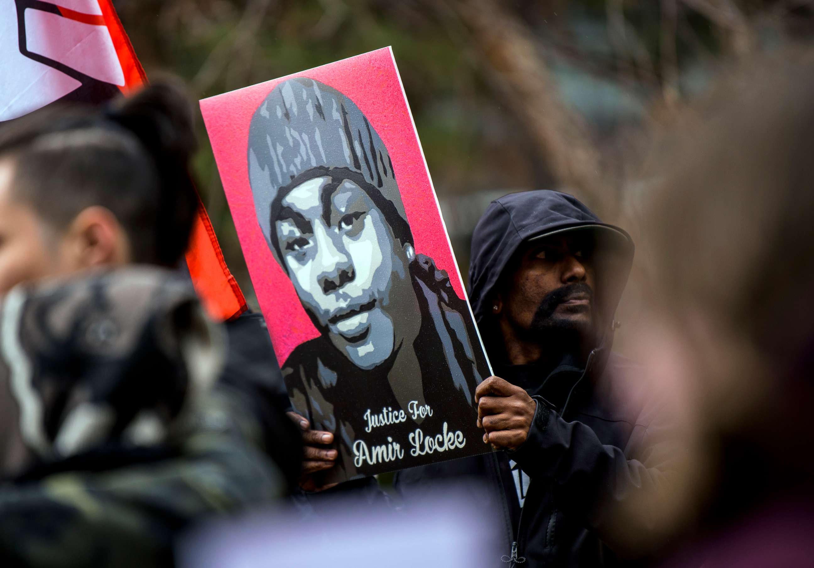 PHOTO: A man holds a portrait of Amir Locke during a news conference outside the Hennepin County Government Center on April 6, 2022, in Minneapolis.